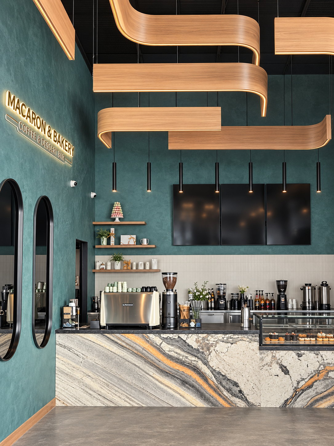 Interior de Macaron and Bakery con barra de mármol y paredes verdes
